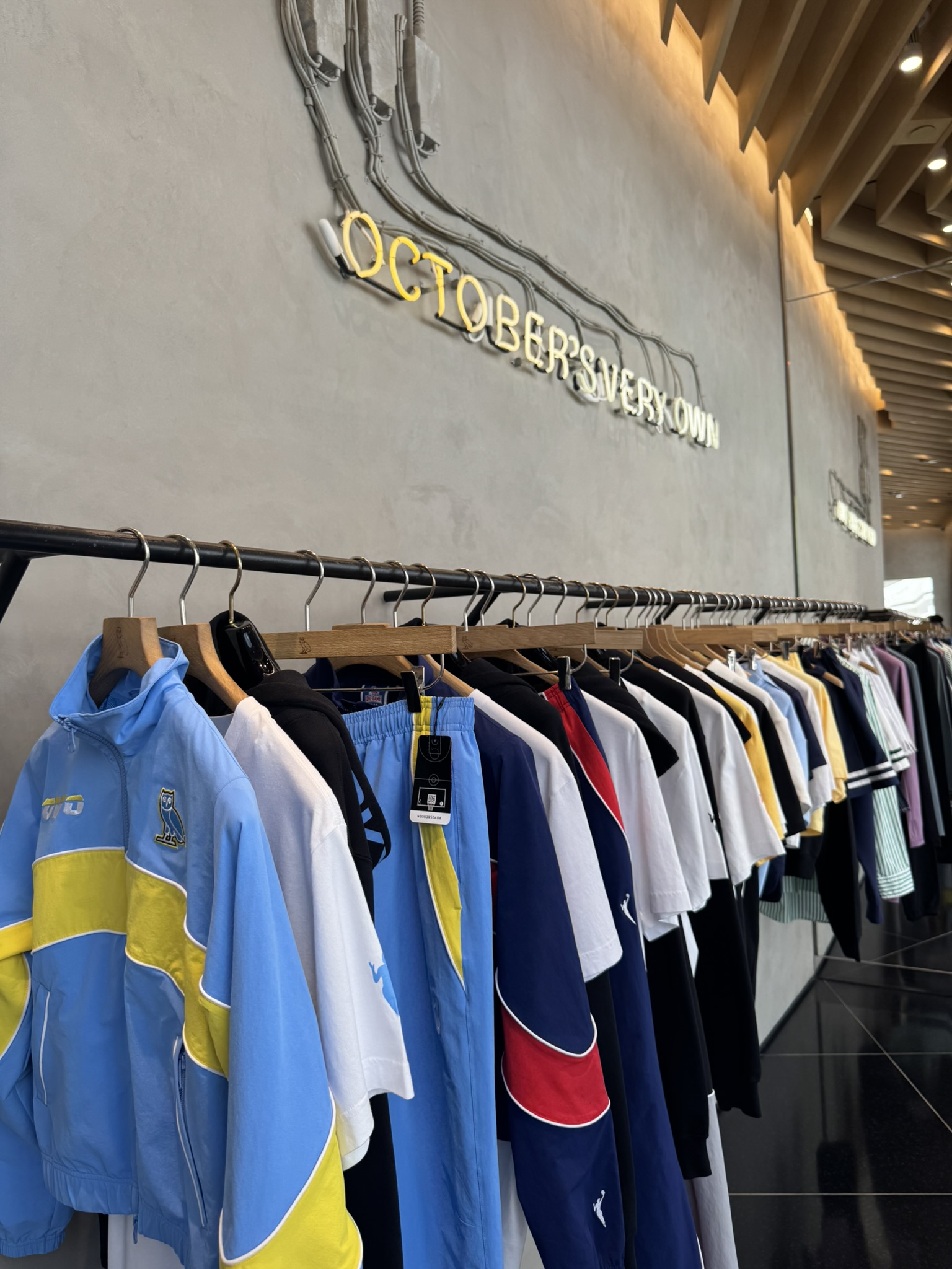 Inside the OVO store in Beverly Hills with clothing displayed on a rack