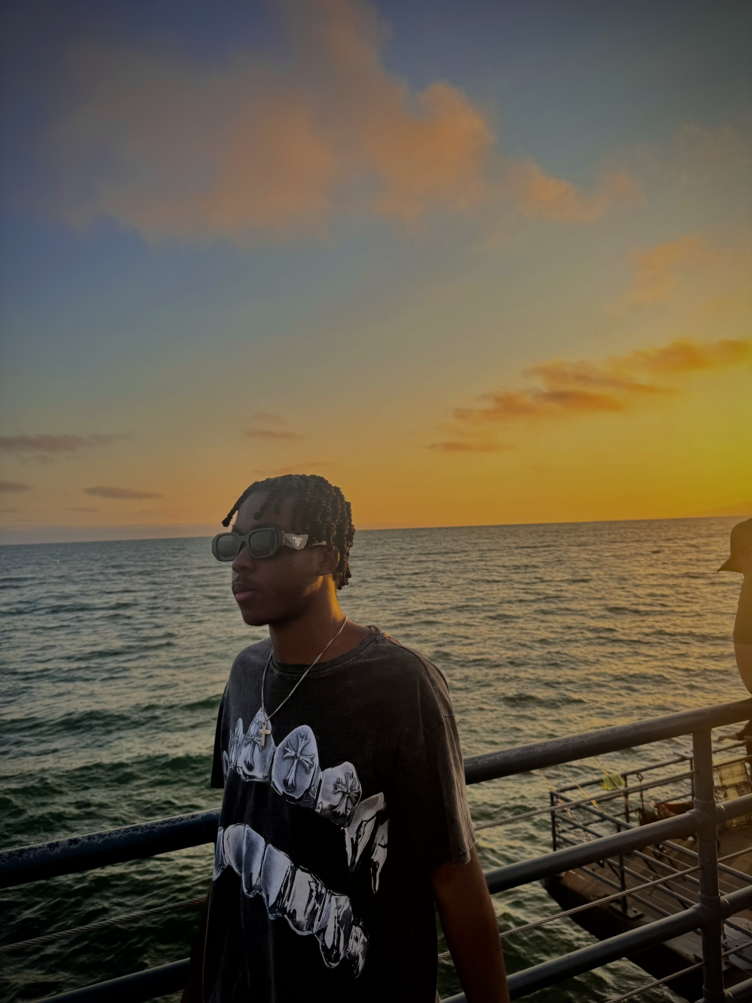 Amir standing near the ocean at sunset in Santa Monica California